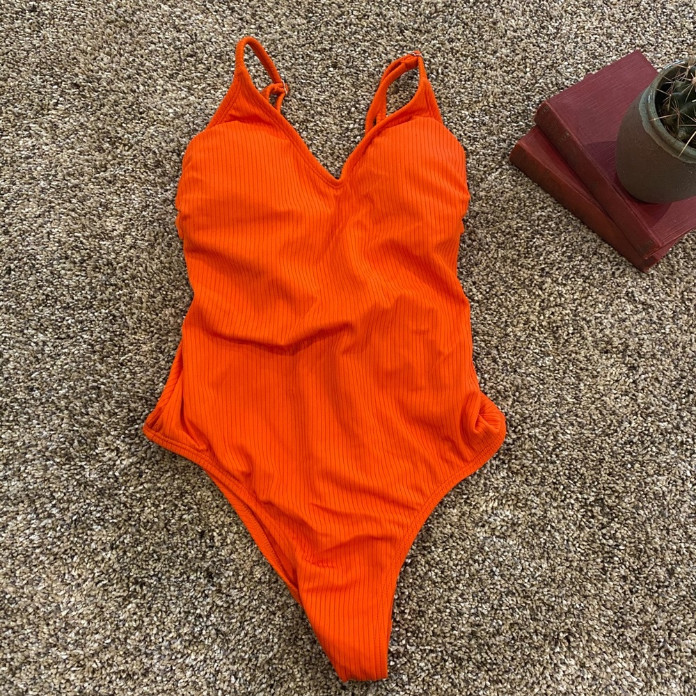 Never worn. Orange high cut swimsuit.